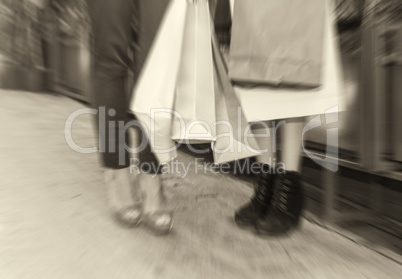 Blurred picture of women making shopping, legs detail