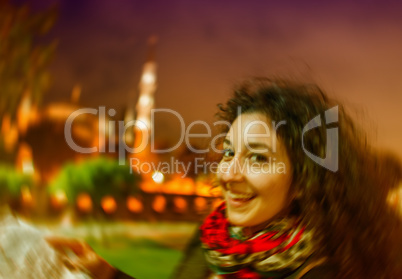 Blurred night view of a girl with map in Sultanahmet, Istanbul