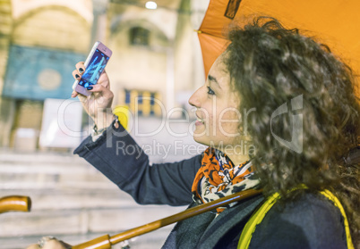 Girl making a selfie in Istanbul Sultanahmet at night