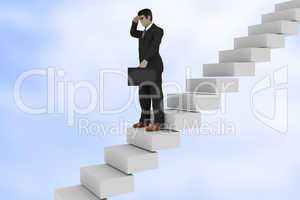 Businessman on the stairs looks back