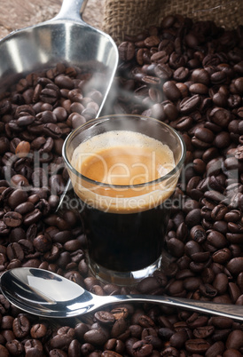 Espresso coffee in glass cup with coffee beans.