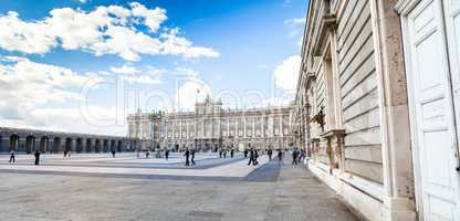 Royal palace with tourists on spring day in Madrid