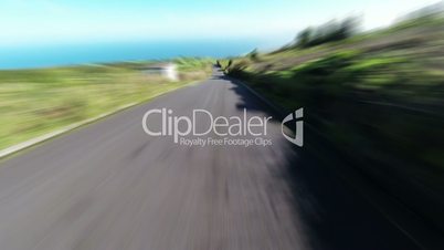 Fast Driving onto Curved Mountain Road on island Sao-Miguel, blurred