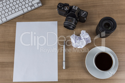 Desktop with camera blank sheet and coffee