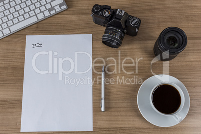 Desktop with camera blank sheet and coffee