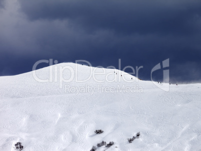 Off-piste slope and storm gray sky in bad weather day