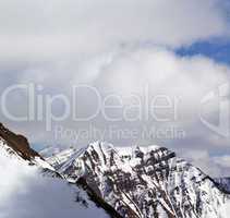 Winter snowy mountains and sky with clouds