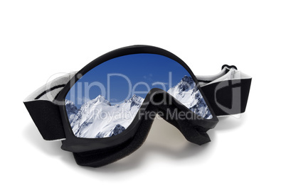 Ski goggles with reflection of snowy mountains in nice day