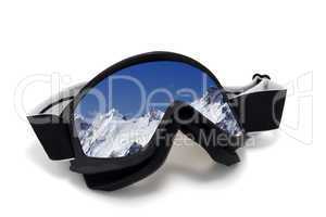 Ski goggles with reflection of snowy mountains in nice day