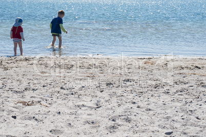 Two kids playing on the beach