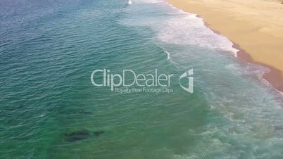 Waves Crashing on Beach, aerial view movement back