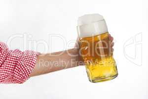 Man in traditional Bavarian shirt holds mug of beer