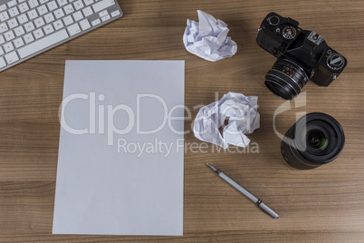 Desktop with camera and blank sheet