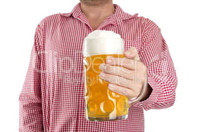 Man in traditional Bavarian shirt holds mug of beer