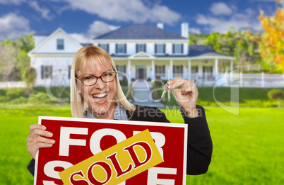 Excited Woman Holding House Keys and Sold Real Estate Sign Excited Woman Holding House Keys and Sold Real Estate Sign