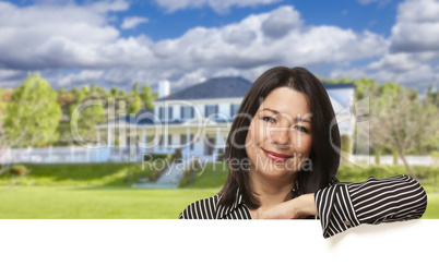 Hispanic Woman Leaning on White in Front of House