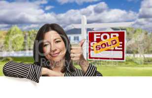 Hispanic Woman in Front of Sold For Sale Sign, House