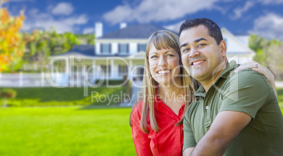 Happy Mixed Race Couple in Front of House