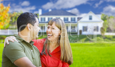 Happy Mixed Race Couple in Front of House