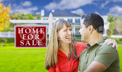 Couple in Front of For Sale Sign and House