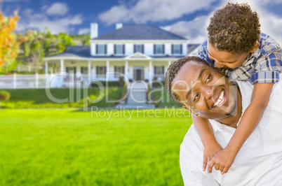 Mixed Race Father and Son In Front of House