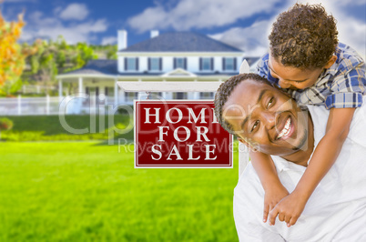 Father and Son In Front of Sale Sign and House