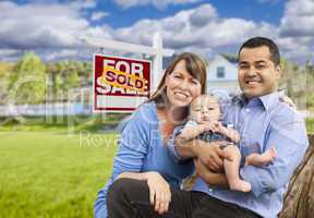 Young Family in Front of Sold Real Estate Sign and House