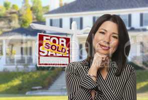Hispanic Woman in Front of Sold Sign and House