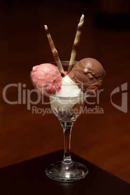 Three ice-creams in champagne glass with wafers