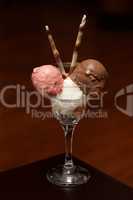 Three ice-creams in champagne glass with wafers
