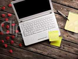 White laptop and hearts with sticky notes