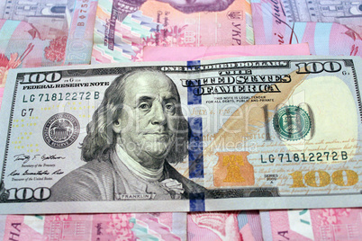 hundred dollars on the Ukrainian grivnas banknotes background