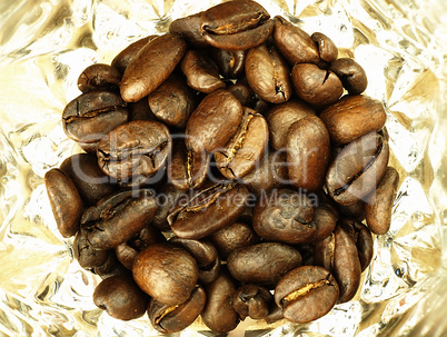 Coffee beans close-up on wooden, oak table.