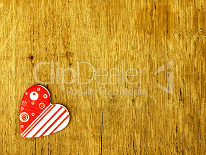 Wooden heart on the oak table.