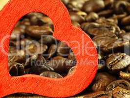 Heart and Coffee beans close-up on wooden, oak table.