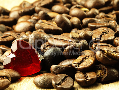 Heart and Coffee beans close-up on wooden, oak table.