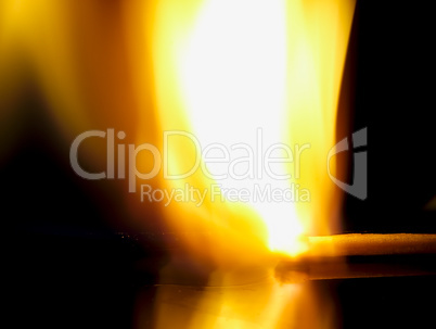 Burning match on a black background.