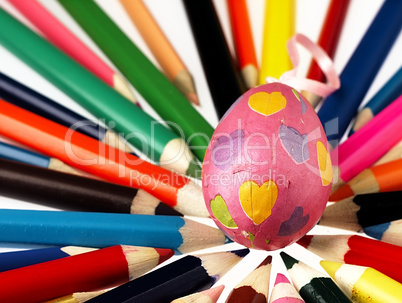 Colorful wooden crayons and Easter egg.