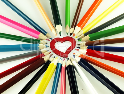 Colorful wooden crayons and red Heart.