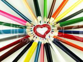 Colorful wooden crayons and red Heart.