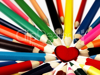 Colorful wooden crayons and red Heart.
