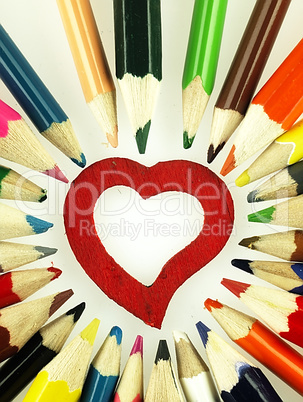 Colorful wooden crayons and red Heart.