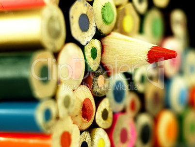 Colorful wooden crayons closely.