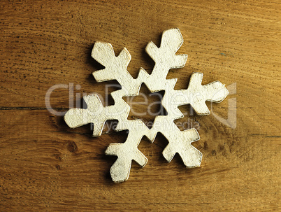 Huge white snowflake and wooden background.