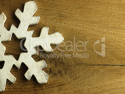 Huge white snowflake and wooden background.