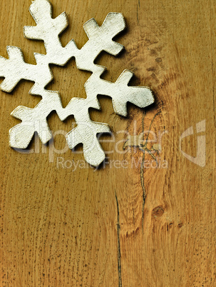 Huge white snowflake and wooden background.