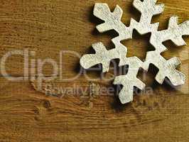 Huge white snowflake and wooden background.