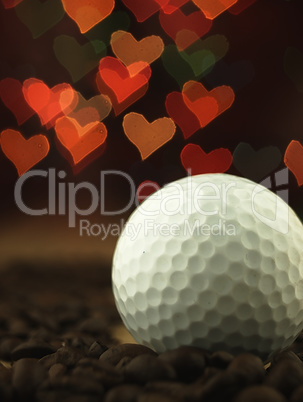 Golf Ball and coffee beans on the table.