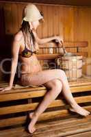 young woman relaxing in a sauna