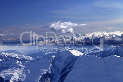 Winter mountains at evening and sunlight clouds